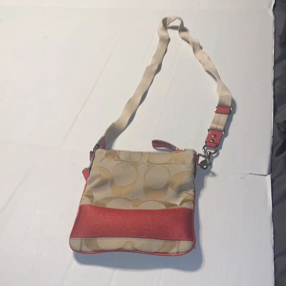 Tan and burnt orange Coach crossbody bag.